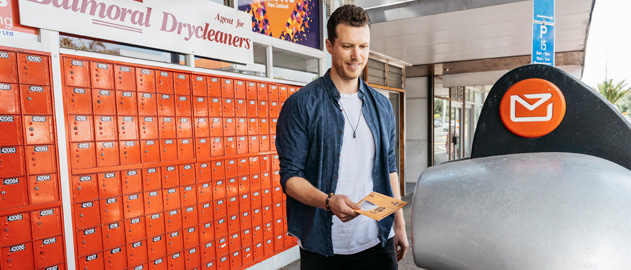 A man posting an envelope.