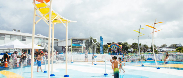 Children playing in a waterpark playground.