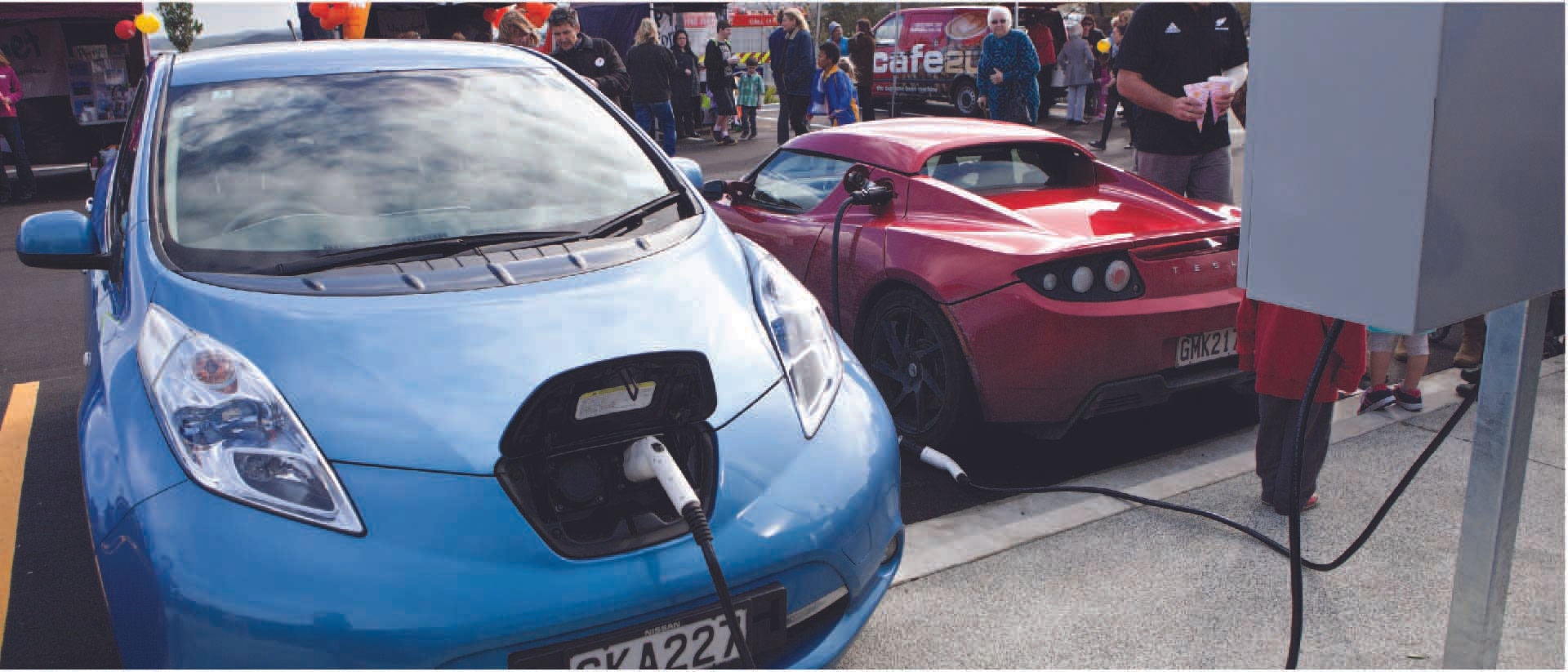 Two electric vehicles sharing a charging station.