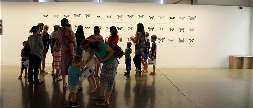 Women and children view an art piece at the Franklin Art Centre.