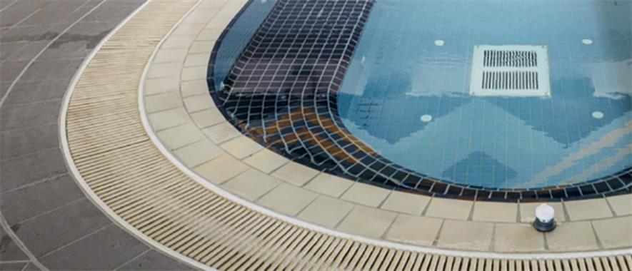 A spa pool lined with small black tiles.