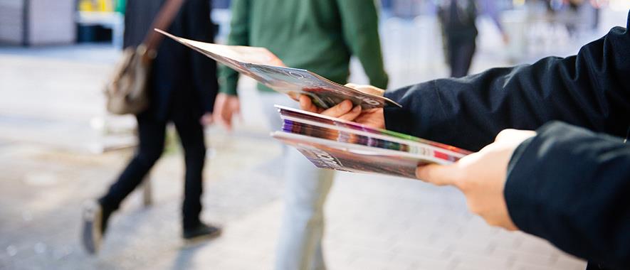 Person handing out flyers.