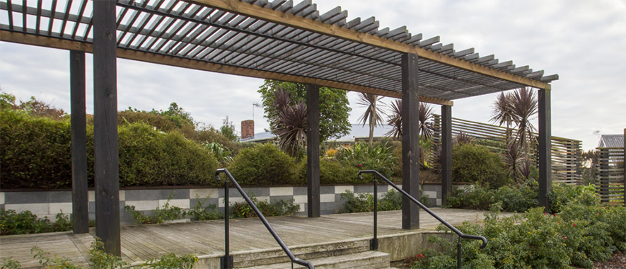 A covered awning that stretches across a walkway.