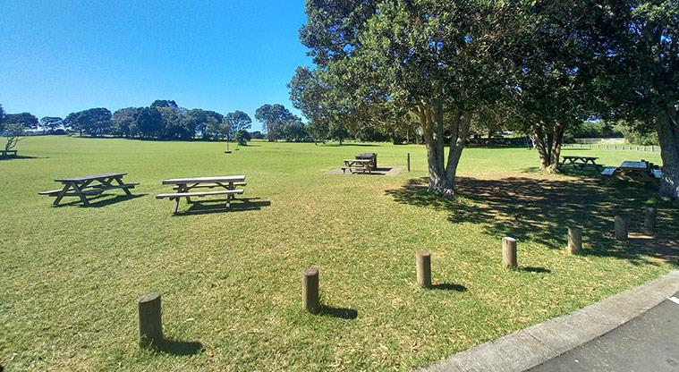 Ambury Regional Park - Bookable site one with picnic tables, and trees for shade.