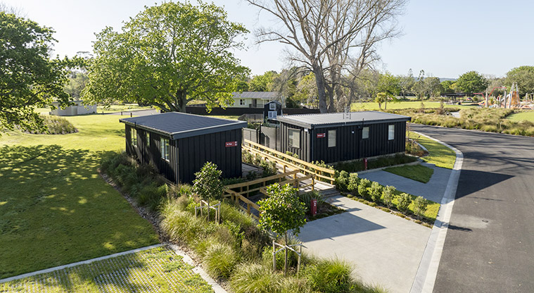 Te Tino tiny home - View of Te Tino from the road with Te Kopua and trees in the background.