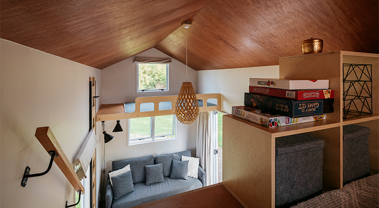 Mahana tiny home - Looking down from the upper level to the living area below.