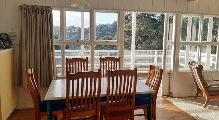 Vine House - Dining area looking outside to the deck and view.