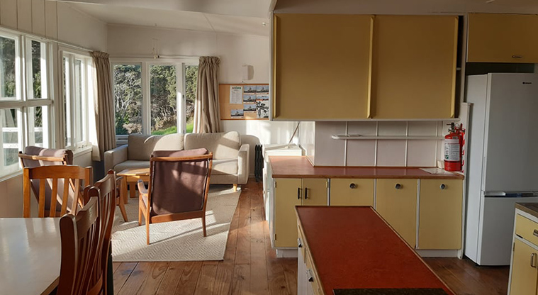 Vine House - Section of the kitchen and dining area with the lounge in the background.