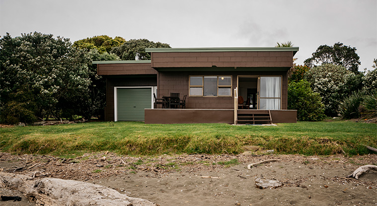 Coldham Bach - Looking at the front of the bach from the water's edge.