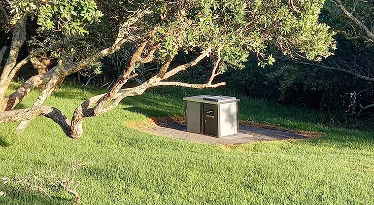 Ōmana Regional Park - Bookable site two barbecue sitting on a flat base under the trees.