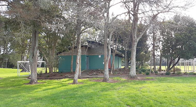 Henderson Park - Open space with trees and the toilet block in the background.