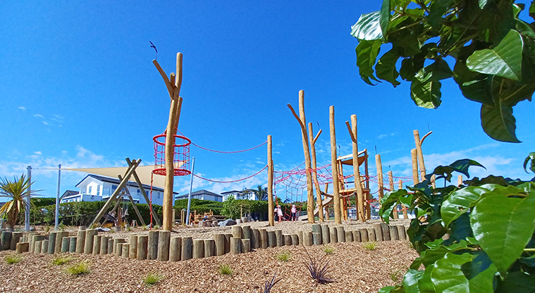 86 Harvest Avenue - A section of the bark garden with tall wooden poles and a variety of climbing nets in the background.