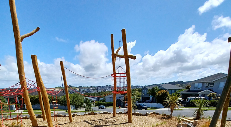 86 Harvest Avenue - One end of the climbing structure with a hanging net basket, climbing ropes and nets.