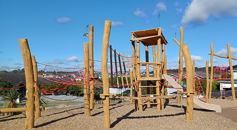 86 Harvest Avenue - A section of the tall wooden climbing structure with rope nets and ladders, a covered tower and a slide.