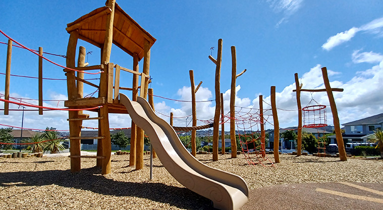 86 Harvest Avenue - Play structure with a slide, and climbing ropes and nets on both sides.