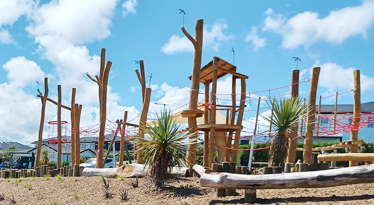 86 Harvest Avenue - A series of balancing logs through the bark garden with the playground in the background.