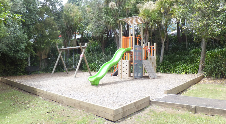 Aitken Reserve - Play module with climbing wall, ladder and slide, and two swings with the path leading into the play area. Photo credit: J Grigg.