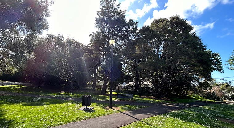 Alice Wylie Reserve - Section of the path with trees, a seat and rubbish bin in the background. Photo credit: S Hulse.