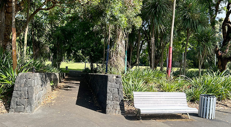 Ballantyne Square -  One of the entrances on the Dominion Road side of the reserve with a seat and rubbish bin on the right. Photo credit: S Hulse.