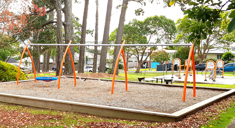 Blockhouse Bay Recreation Reserve - Swings with fitness equipment in the background.