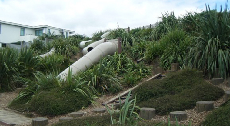 Bramley Drive Reserve - Playground with snakes and ladder slides nestled on the side of the bank.