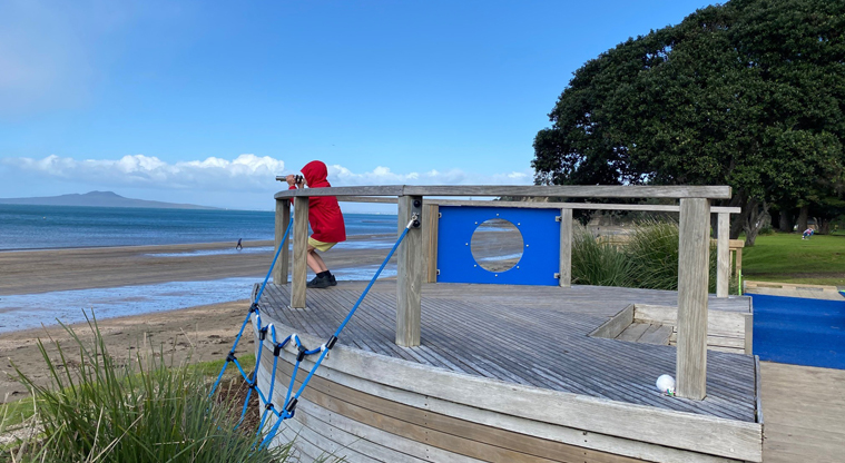Browns Bay Beach Reserve - The deck of a ship with a pair of binoculars at the end overlooking Rangitoto Island. Photo credit: T Hodder.