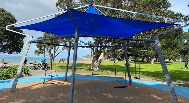 Browns Bay Beach Reserve - Set of swings under shade. Photo credit: T Hodder.