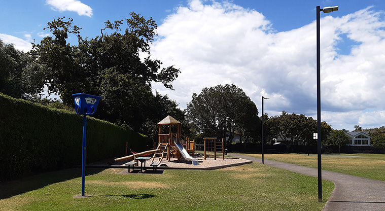 Centennial Park - Open space, and a footpath alongside the playground.