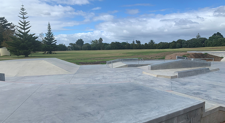 Ngahere Ki Uta / Clarks Beach Recreational Reserve and Golf Club - Section of the skate park with open grassed space and trees in the background.