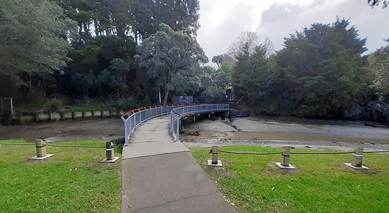 Cockle Bay Reserve - Bollards and the bridge at the northern end of the reserve leading over the inlet to Tainui Road.
