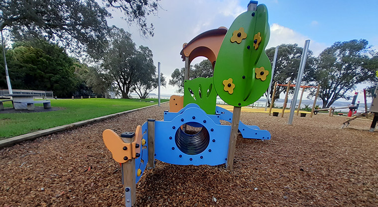 Cockle Bay Reserve - Part of the junior play module with a covered platform, blue tunnel and slide.
