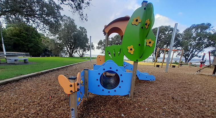 Cockle Bay Reserve - Part of the junior play module with a covered platform, blue tunnel and slide.