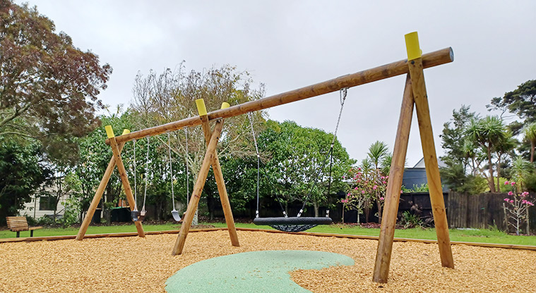 Collins Park - Swing set with a basket swing, a sling swing and a bucket swing.