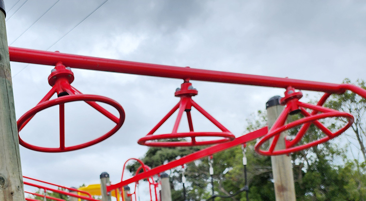 Toetoe-roa / Cooper Park - Round red spinners for hanging and swinging across.
