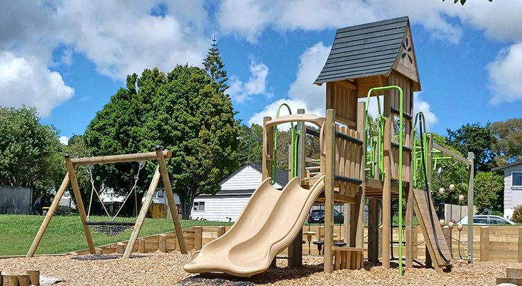 Cranston Street Reserve - Play module with a double slide, ramps, climbing equipment and poles, with the basket swing on the left.