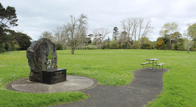 Cranwell Park - The Elvis memorial with open space, picnic table and trees in the background.