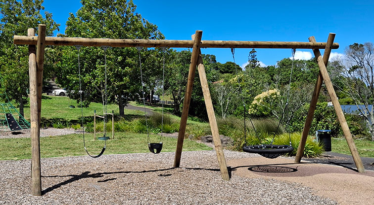 Tahurangi / Crum Park - Swing set in the main play area with a junior bucket seat, senior strap seat and a basket swing. Photo credit: T Hodder.