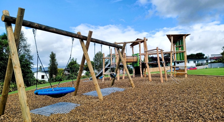 Dalmatia Green - Set of three swings including a basket swing, and the play module with climbing equipment, a crawl tunnel and a slide.