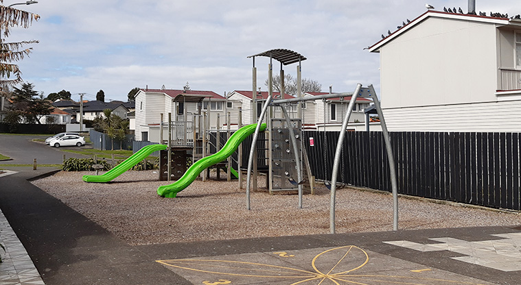 Delphine Close - Playground with climbing towers and bridge, slides, climbing wall, slides, spinning seat, rocker, and swings. Photo credit: S Hulse.
