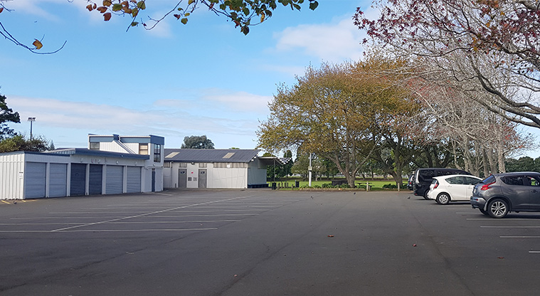 Eastdale Reserve - Large car park with community spaces and storage sheds in the background.