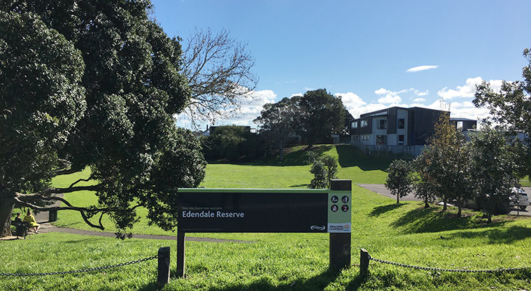 Edendale Reserve - Sign at the Sandringham Road entrance with the sports field in the background. Photo credit: S Hulse.