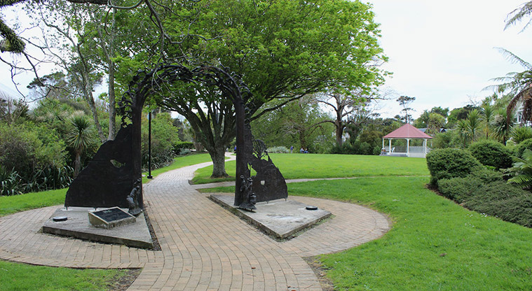 Falls Park - Sculpture on the path with open space, trees and the band rotunda in the background.