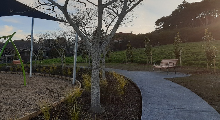 Ferry Road / Hawaiian Parade junction - Path with playground on one side and bench on other side.