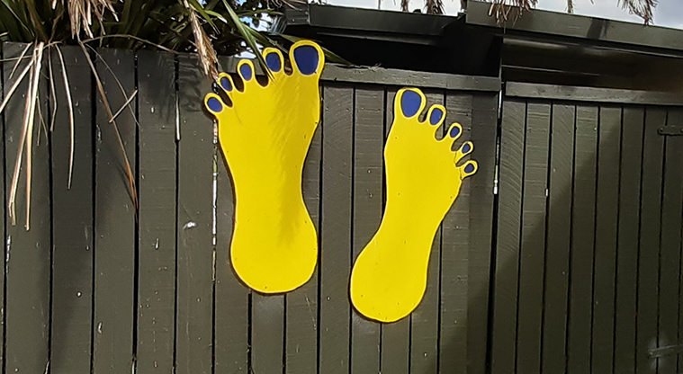 Freyberg Field - Large yellow foot shapes attached to the fence at the entrance to the fields. Photo credit: S Hulse.