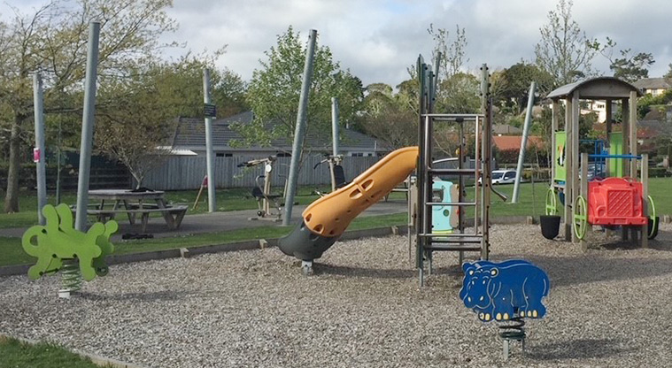 Glasgow Park - Rocker toys and slide with fitness equipment in the background. Photo credit: T Hodder.