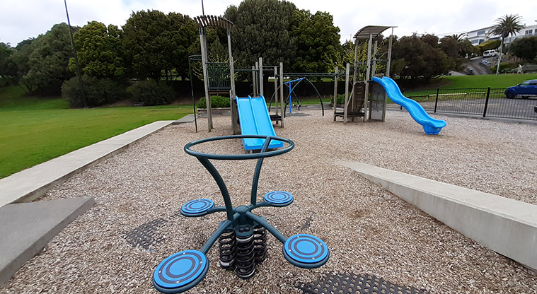 Glover Park - Spinning rocker with the rest of the playground in the background.