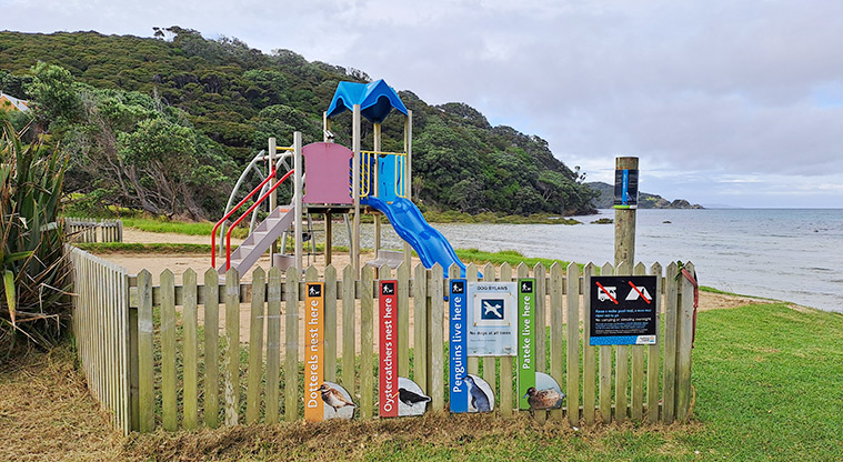 Gooseberry Flat - Play ground with a wooden picket fence surrounding two sides, and signs attached to the fence.