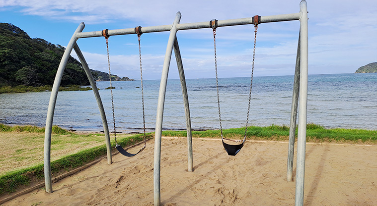 Gooseberry Flat - Swings with view of Puriri Bay in the background.