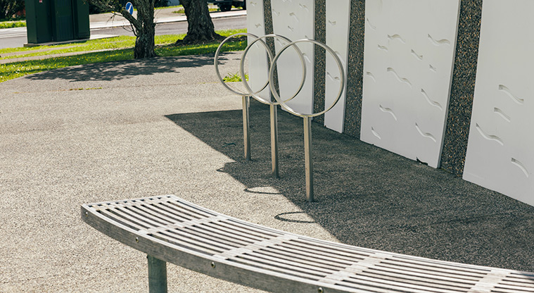 Greville Reserve - Part of a seat and some bike racks at the end of the toilet and changing room block. Photo credit: J Farnworth.