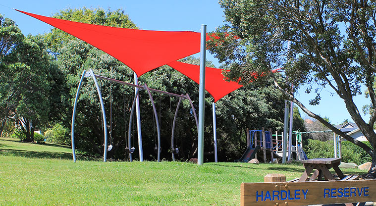 Hardley Reserve - Swings covered by large red shade sails. Photo credit: M Loubser.